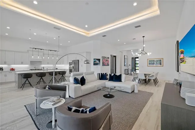 a living room with furniture and a chandelier