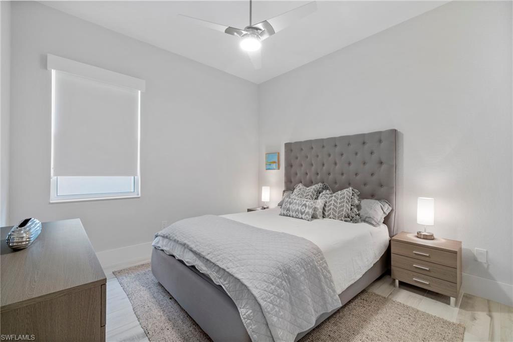 6136 Rodney Bay Lane Naples, FL 34113 - Photo 22 of 29 a bedroom with a bed and a window