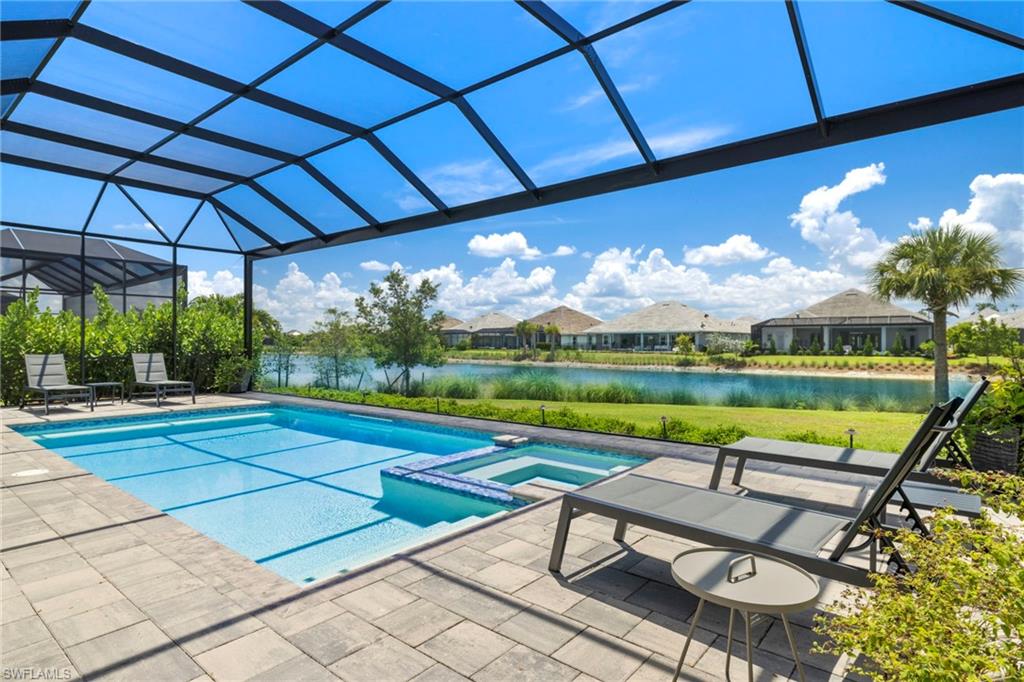 6136 Rodney Bay Lane Naples, FL 34113 - Photo 27 of 29 a view of swimming pool with outdoor seating and yard