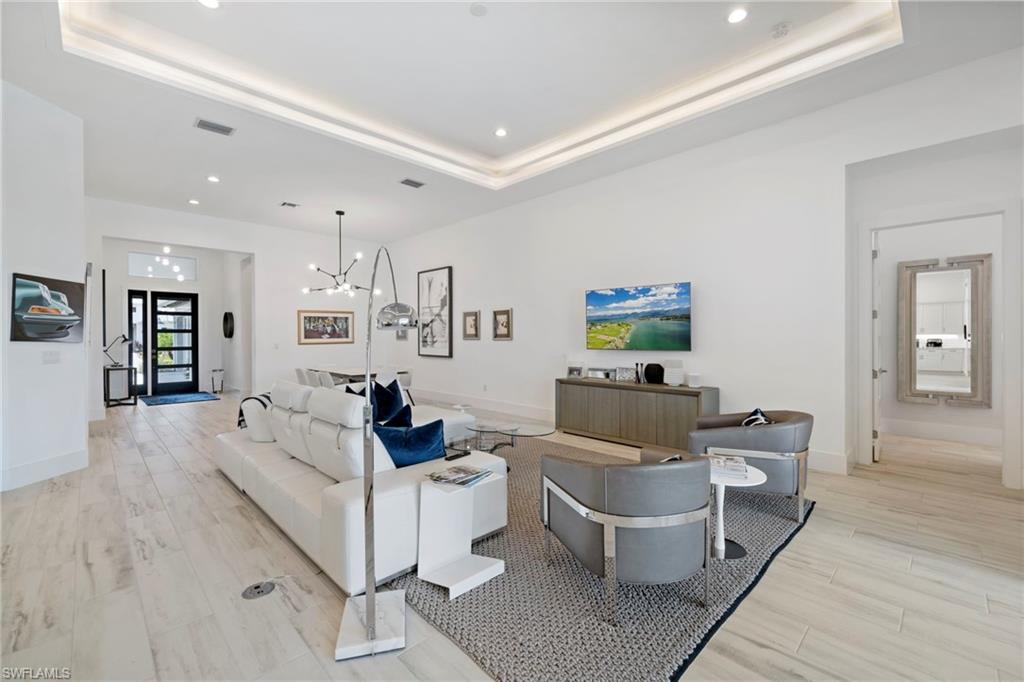 6136 Rodney Bay Lane Naples, FL 34113 - Photo 3 of 29 a living room with furniture and a flat screen tv