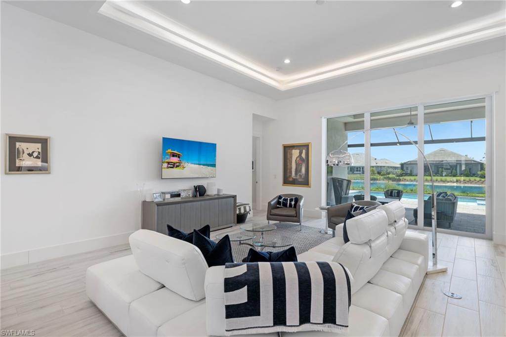 6136 Rodney Bay Lane Naples, FL 34113 - Photo 4 of 29 a living room with furniture and a large window