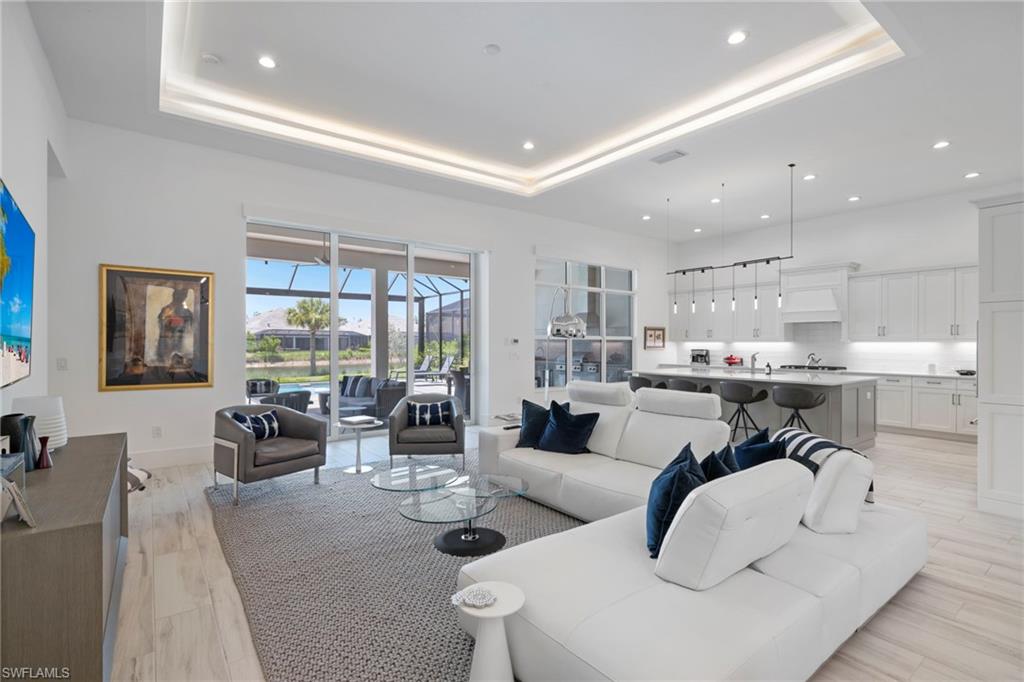 6136 Rodney Bay Lane Naples, FL 34113 - Photo 5 of 29 a living room with furniture and a large window