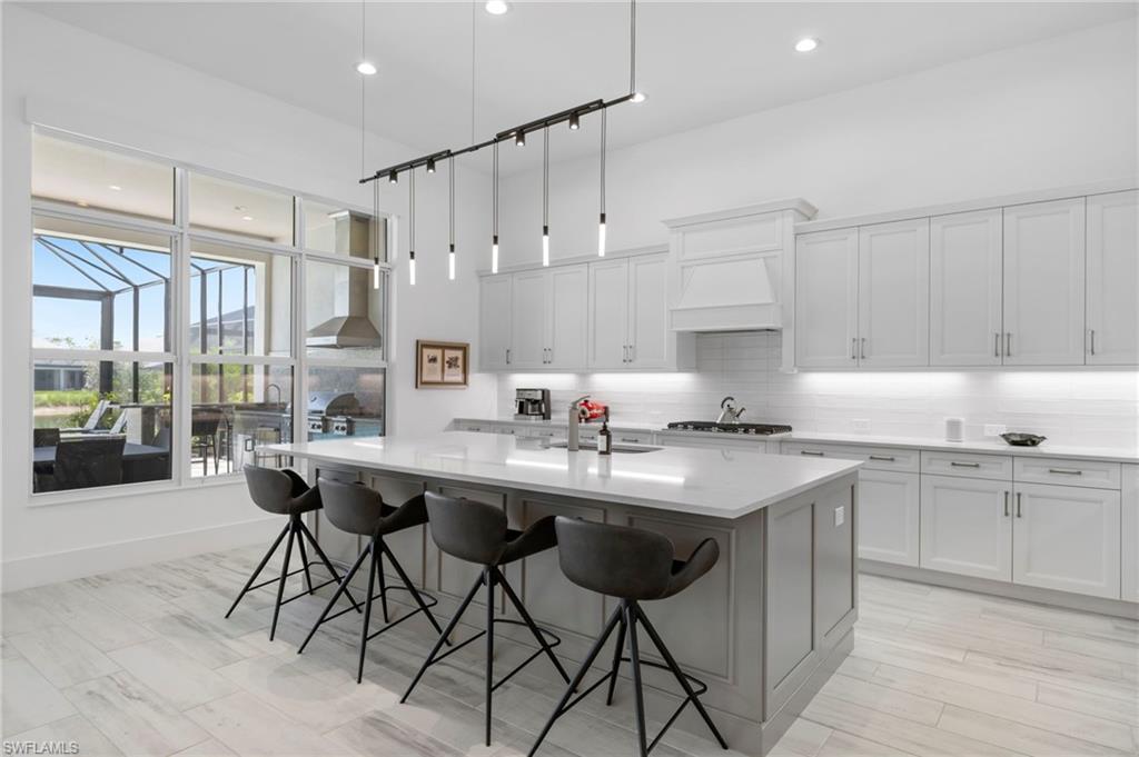 6136 Rodney Bay Lane Naples, FL 34113 - Photo 6 of 29 a kitchen with a sink and cabinets