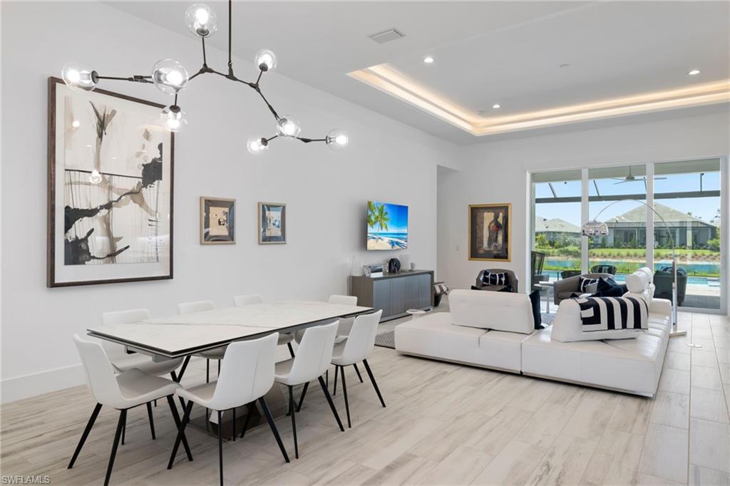 6136 Rodney Bay Lane Naples, FL 34113 - Photo 10 of 29 a living room with furniture and a large window