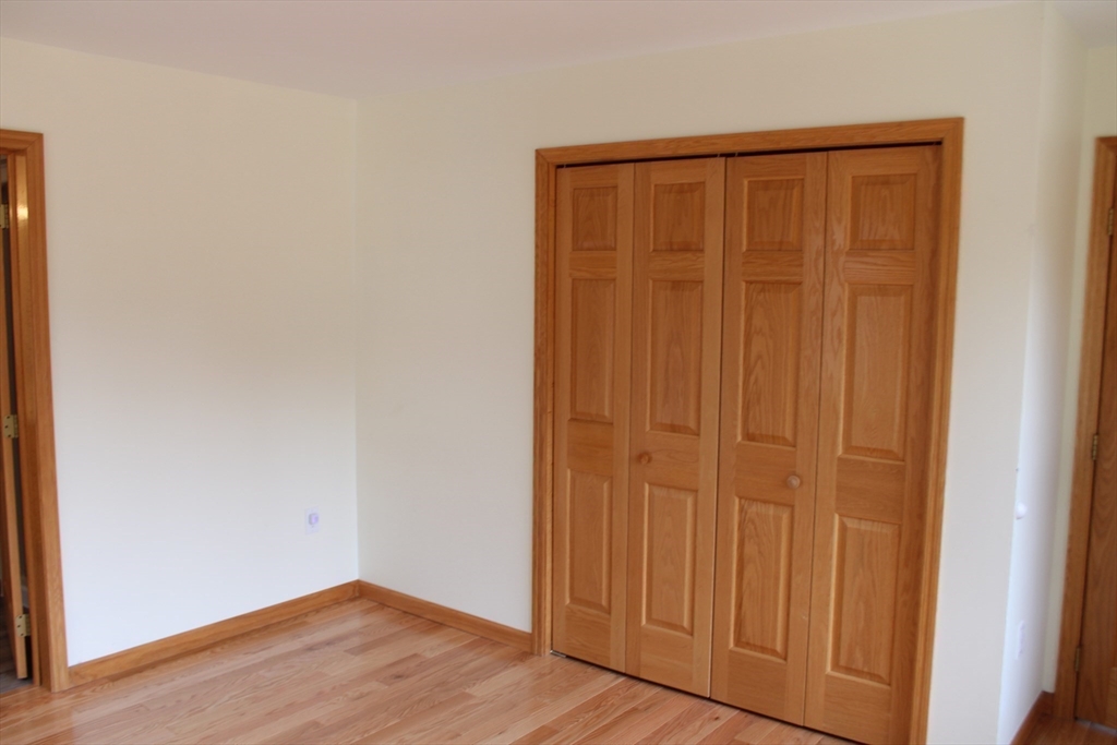 59 Strowbridge Road Northfield, MA 01360 - Photo 13 of 26 an empty room with wooden floor and closet area