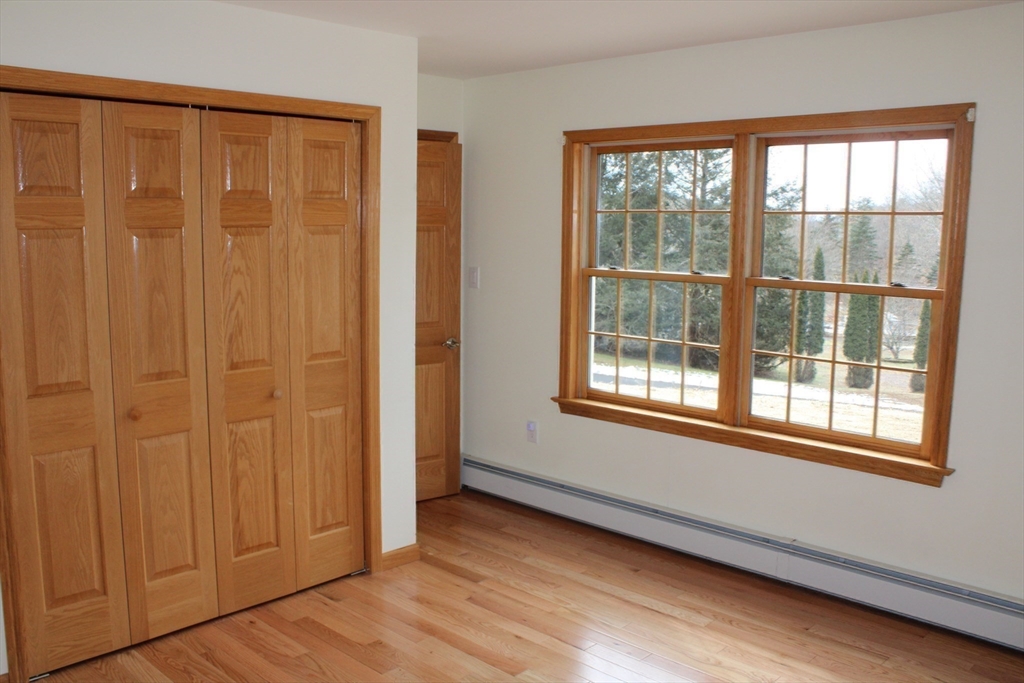 59 Strowbridge Road Northfield, MA 01360 - Photo 14 of 26 an empty room with wooden floor and windows