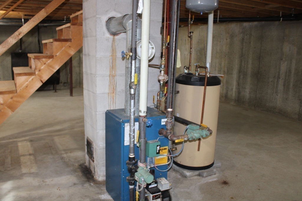 59 Strowbridge Road Northfield, MA 01360 - Photo 25 of 26 a room with water heater and racks on the wall