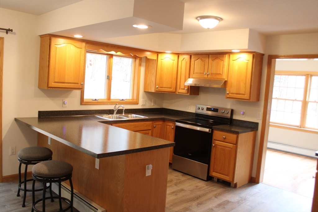 59 Strowbridge Road Northfield, MA 01360 - Photo 9 of 26 a kitchen with kitchen island granite countertop a stove and a sink