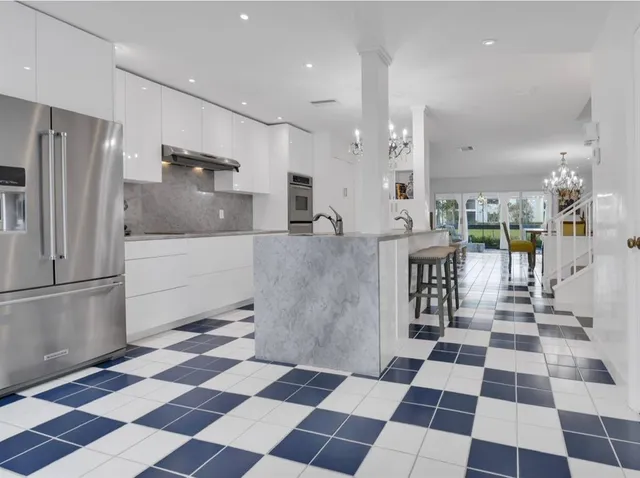 a large white checkered floor in a kitchen with a checkered floor and a refrigerator