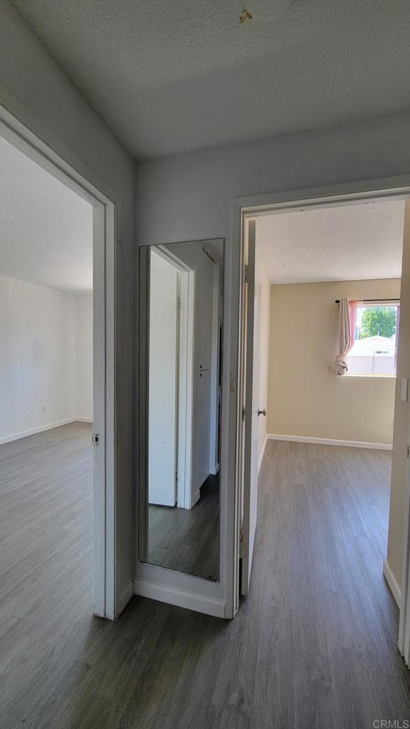 742 A Street, Unit 15 Ramona, CA 92065 - Photo 15 of 18 an empty room with wooden floor mirror and windows