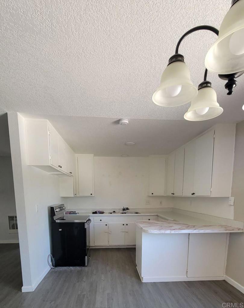 742 A Street, Unit 15 Ramona, CA 92065 - Photo 3 of 18 a view of kitchen with stainless steel appliances cabinets and wooden floor