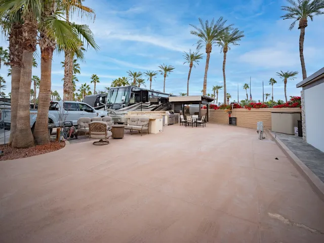 a view of a patio with a table and chairs