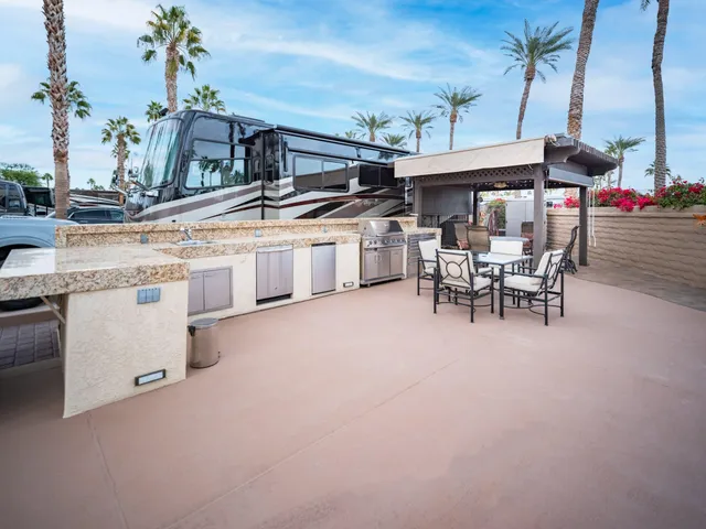 a outdoor living space with patio furniture and a fireplace