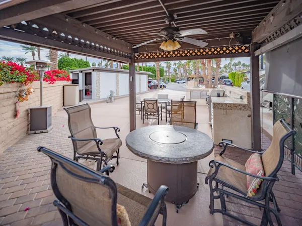 a view of a patio with dining table and chairs