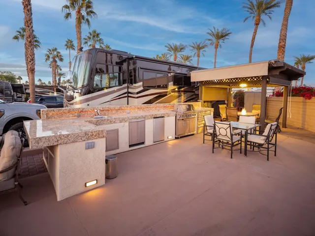 a view of a backyard with a patio and swimming pool