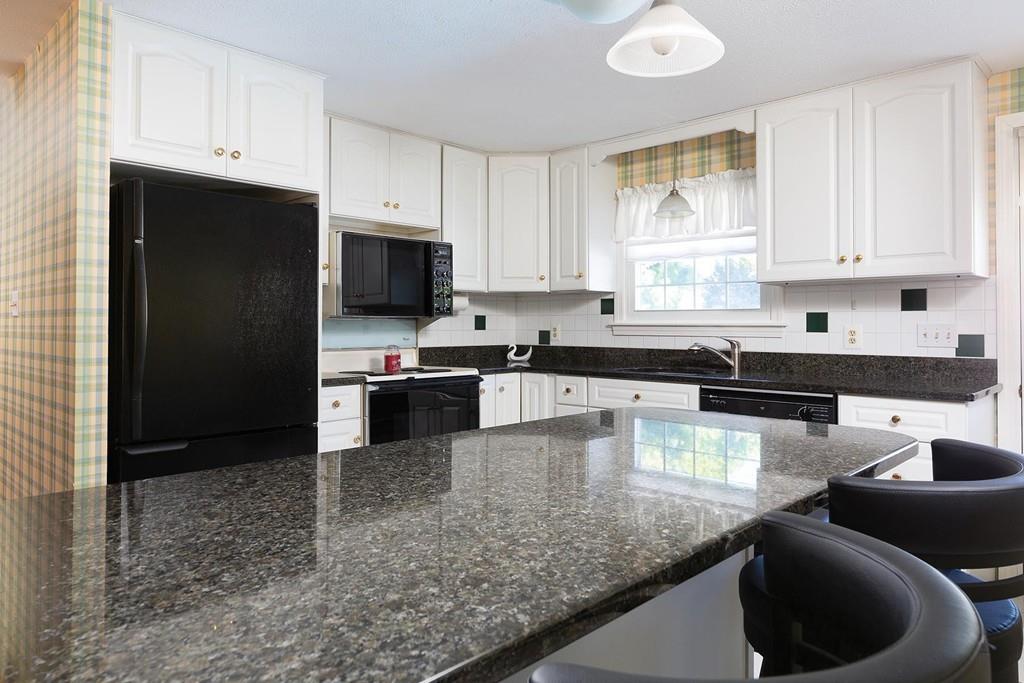 114 Huntington Road Milton, MA 02186 - Photo 6 of 9 a kitchen with granite countertop a sink a stove a refrigerator and cabinets