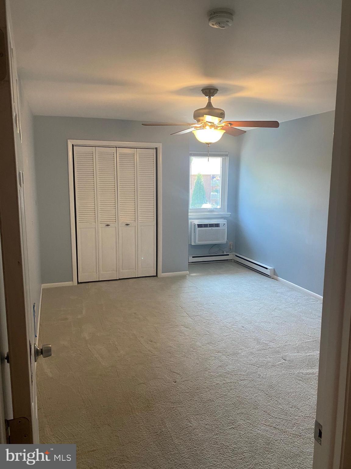300 Winding Way, Unit B16 Downingtown, PA 19335 - Photo 12 of 21 an empty room with a ceiling fan and a window
