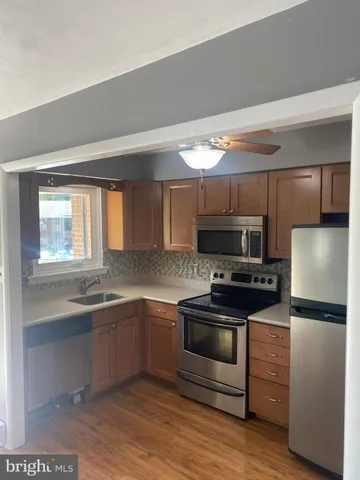 a kitchen with stainless steel appliances a stove a sink and a refrigerator