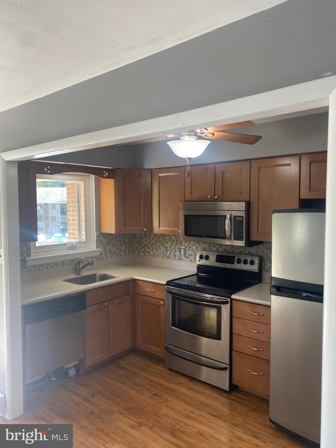 300 Winding Way, Unit B16 Downingtown, PA 19335 - Photo 7 of 21 a kitchen with stainless steel appliances a stove a sink and a refrigerator