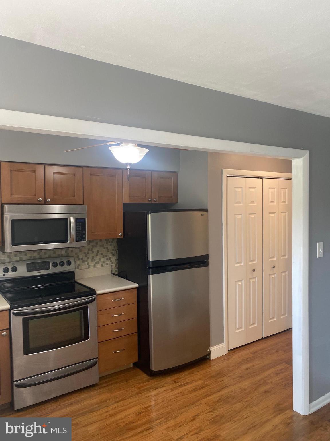 300 Winding Way, Unit B16 Downingtown, PA 19335 - Photo 9 of 21 a kitchen with a refrigerator stove and wooden cabinets