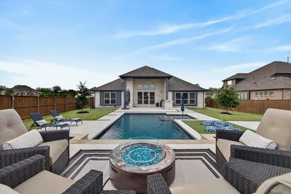 a view of a house with couches chairs and a yard