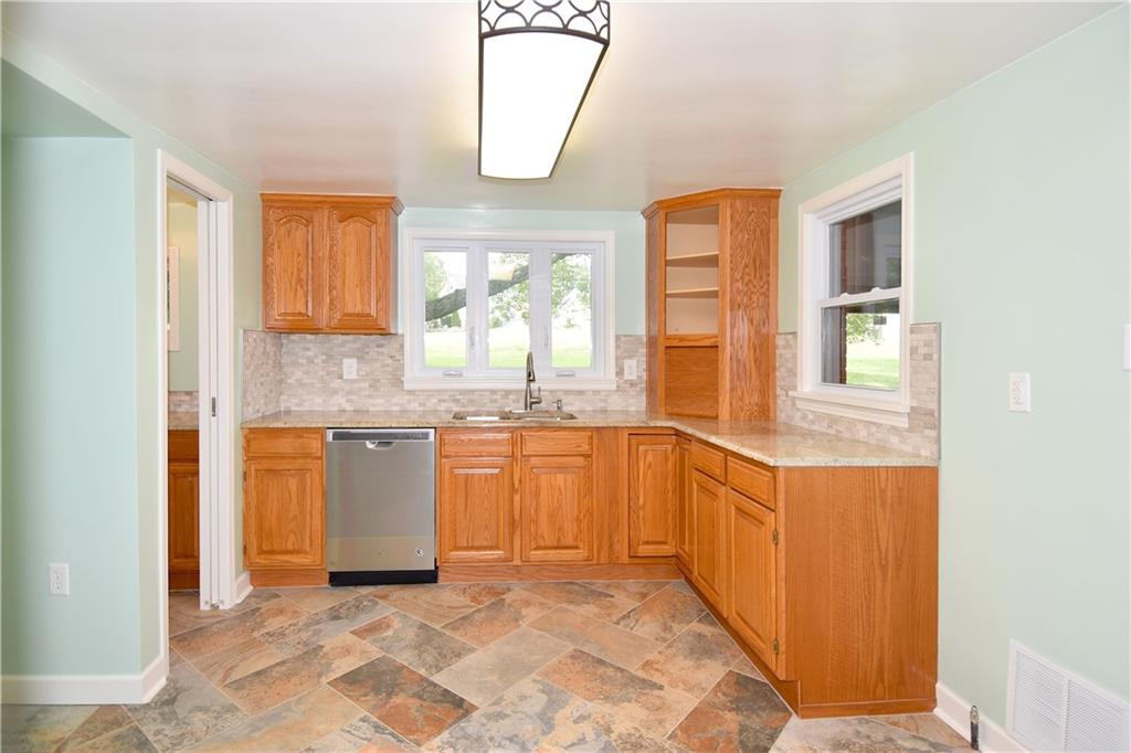 1195 Harvey Run Road Freedom, PA 15042 - Photo 8 of 19 The kitchen has been completely renovated with new countertops, a new kitchen floor, and stunning backsplash!