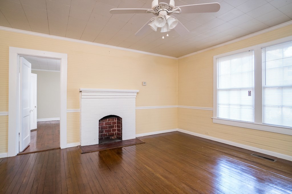 7523 Columbus Road Lizella, GA 31052 - Photo 3 of 21 a view of an empty room with wooden floor and a window