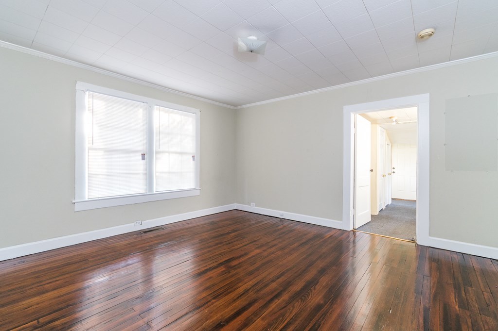 7523 Columbus Road Lizella, GA 31052 - Photo 8 of 21 an empty room with wooden floor and windows