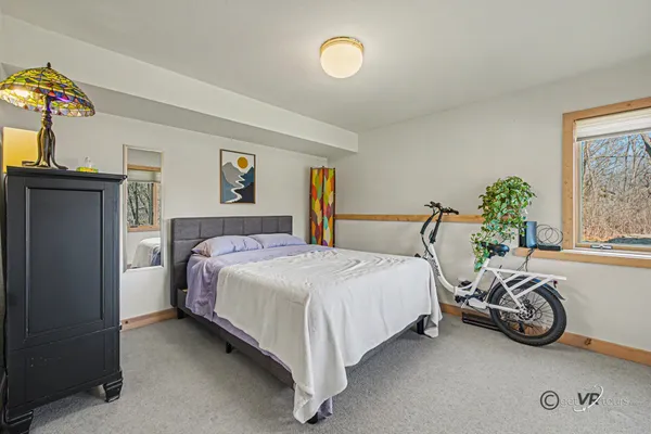a bedroom with a bed and glass window