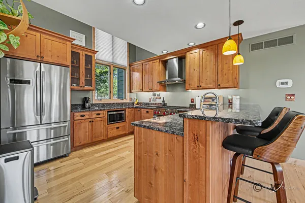 a kitchen with stainless steel appliances granite countertop a stove a sink and a granite counter tops