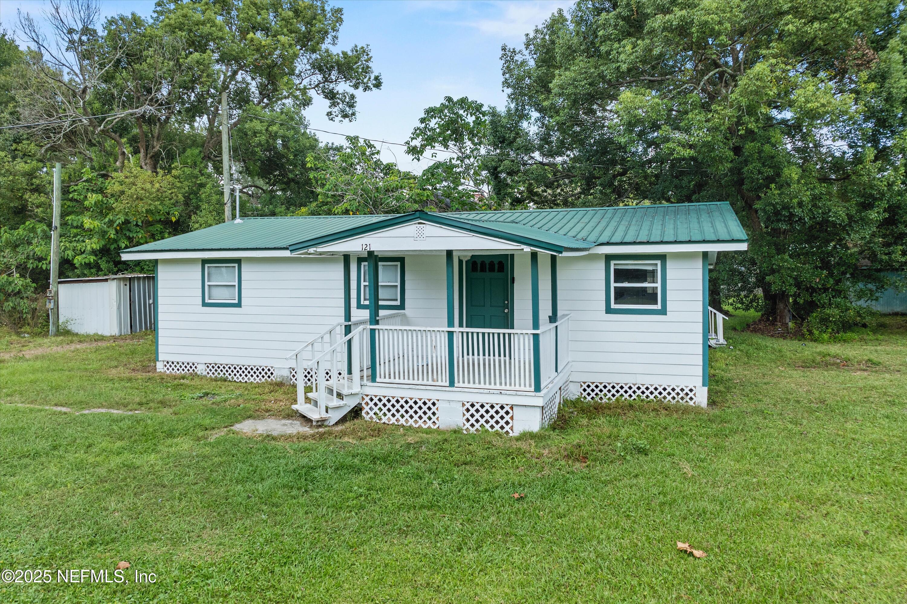 123 Mccallman Road Jacksonville, FL 32218 - Photo 11 of 62 a backyard of a house with table and chairs