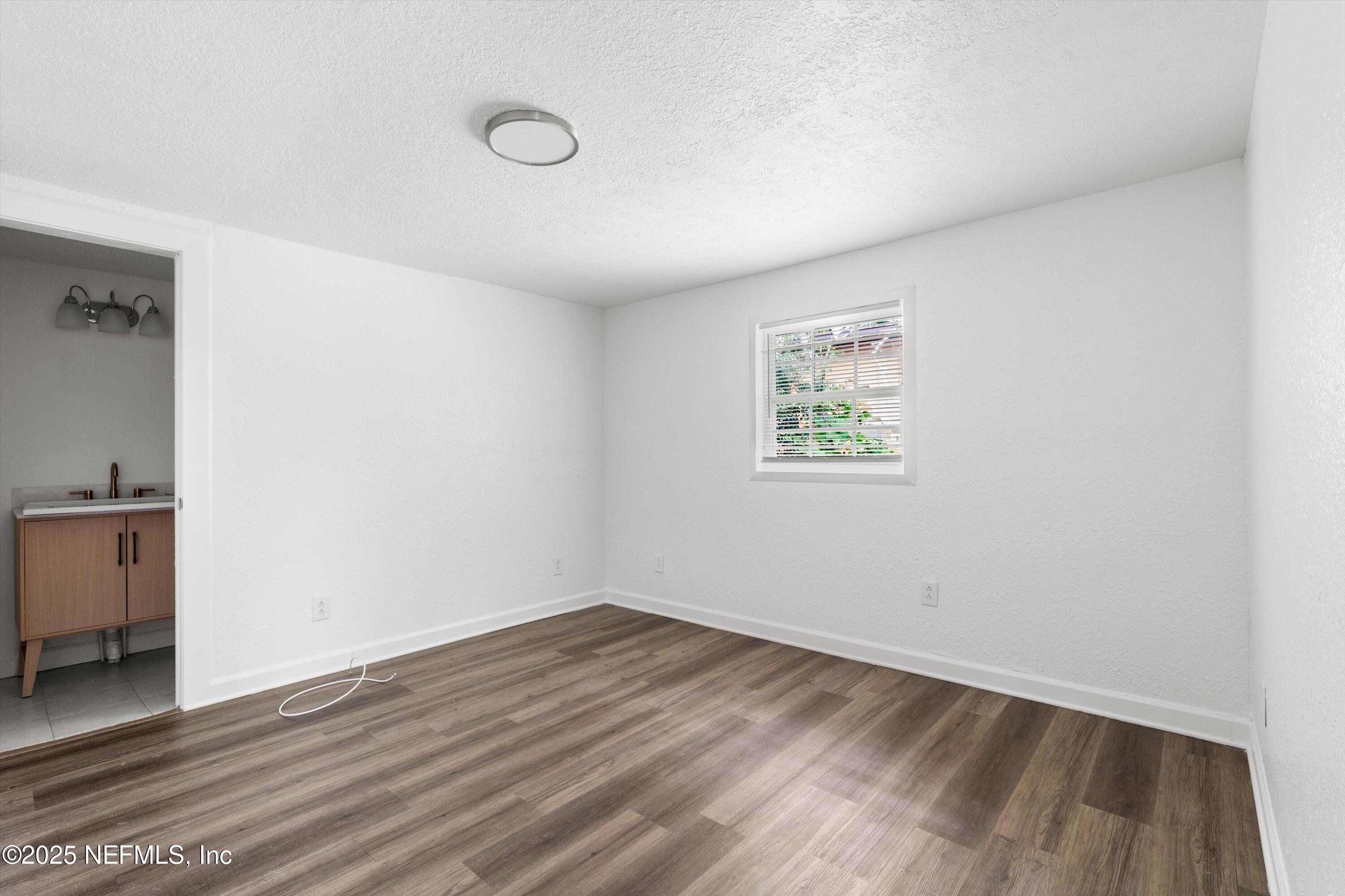 123 Mccallman Road Jacksonville, FL 32218 - Photo 14 of 62 an empty room with wooden floor and windows