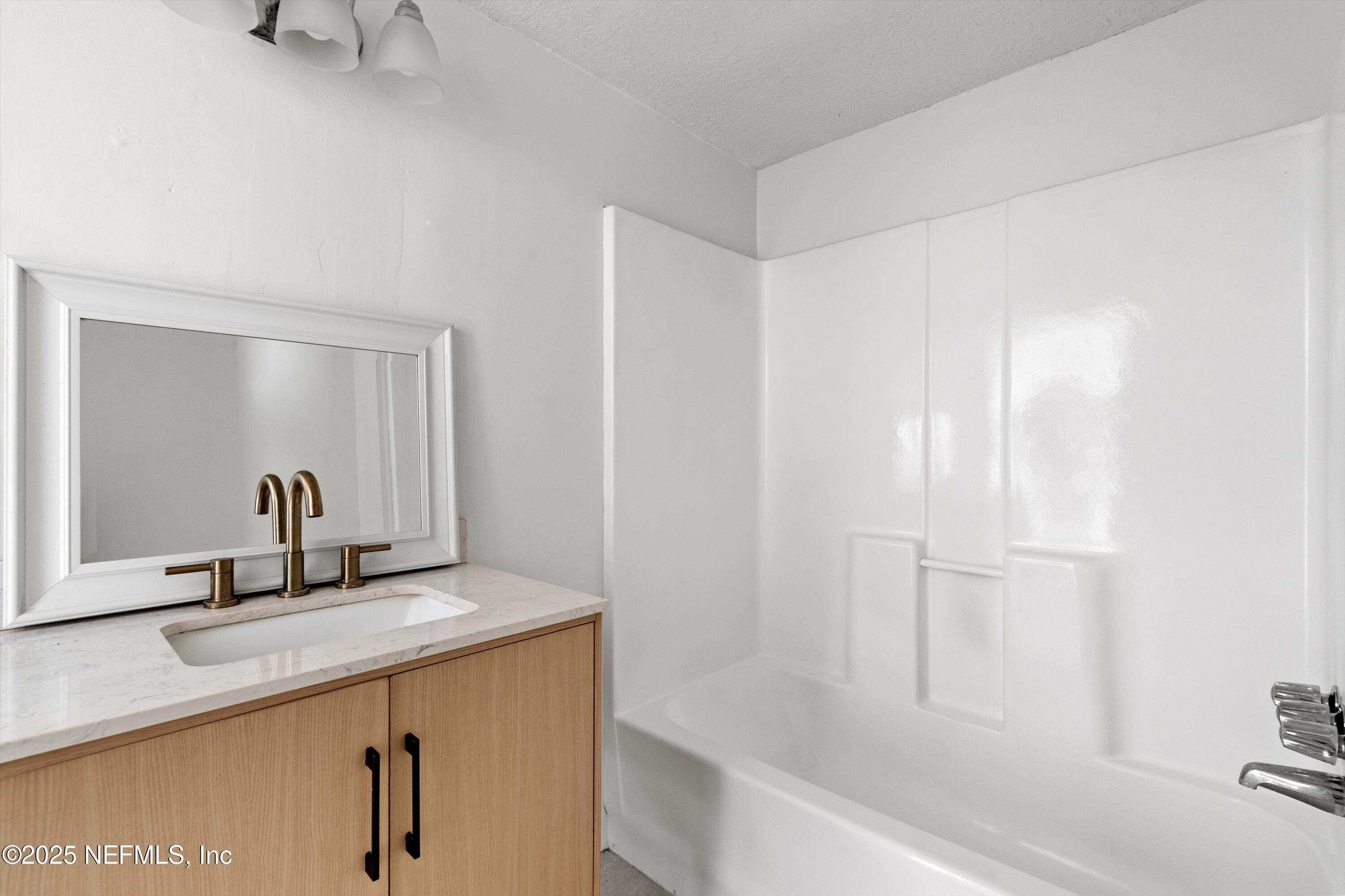 123 Mccallman Road Jacksonville, FL 32218 - Photo 17 of 62 a bathroom with a sink and a mirror