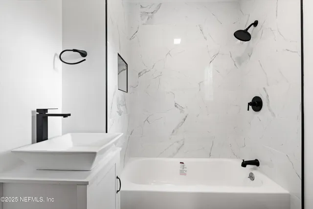 a bathroom with a bathtub and a shower