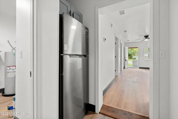 a kitchen with stainless steel appliances granite countertop white cabinets granite counter tops and a window