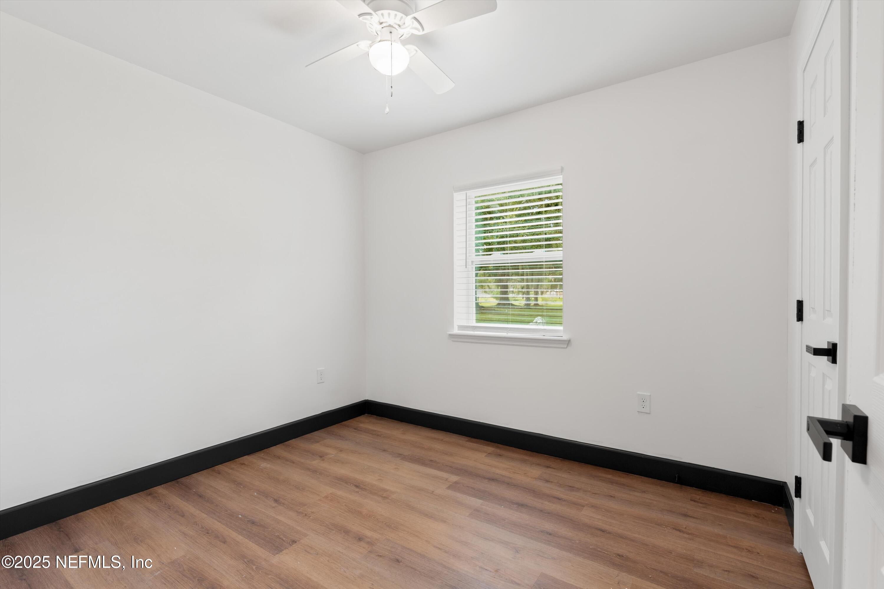 123 Mccallman Road Jacksonville, FL 32218 - Photo 27 of 62 an empty room with wooden floor and windows