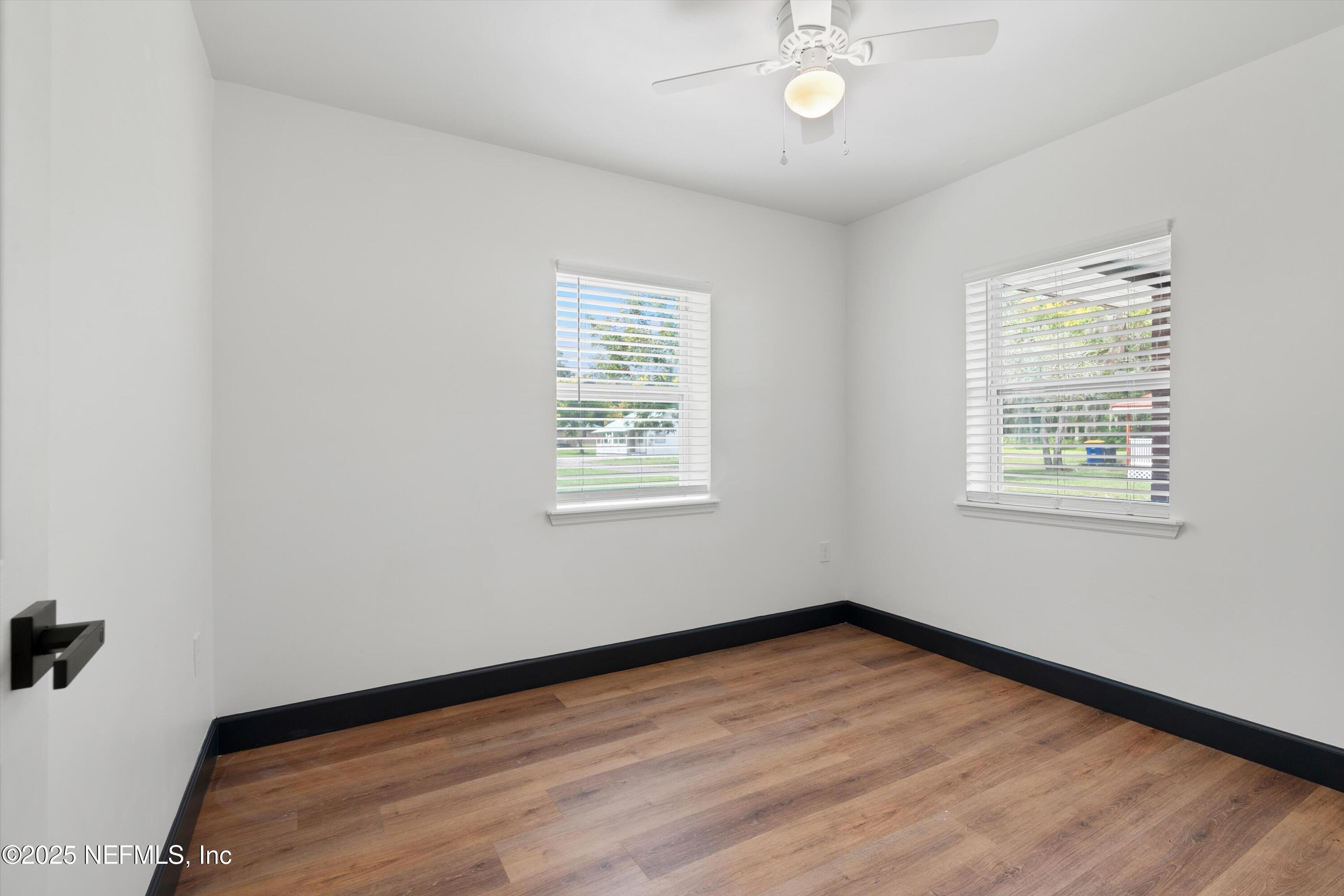 123 Mccallman Road Jacksonville, FL 32218 - Photo 28 of 62 a view of empty room with wooden floor and fan