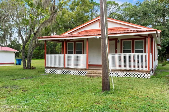 a view of a house with a yard and deck
