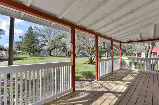 a view of a porch with wooden floor of the house