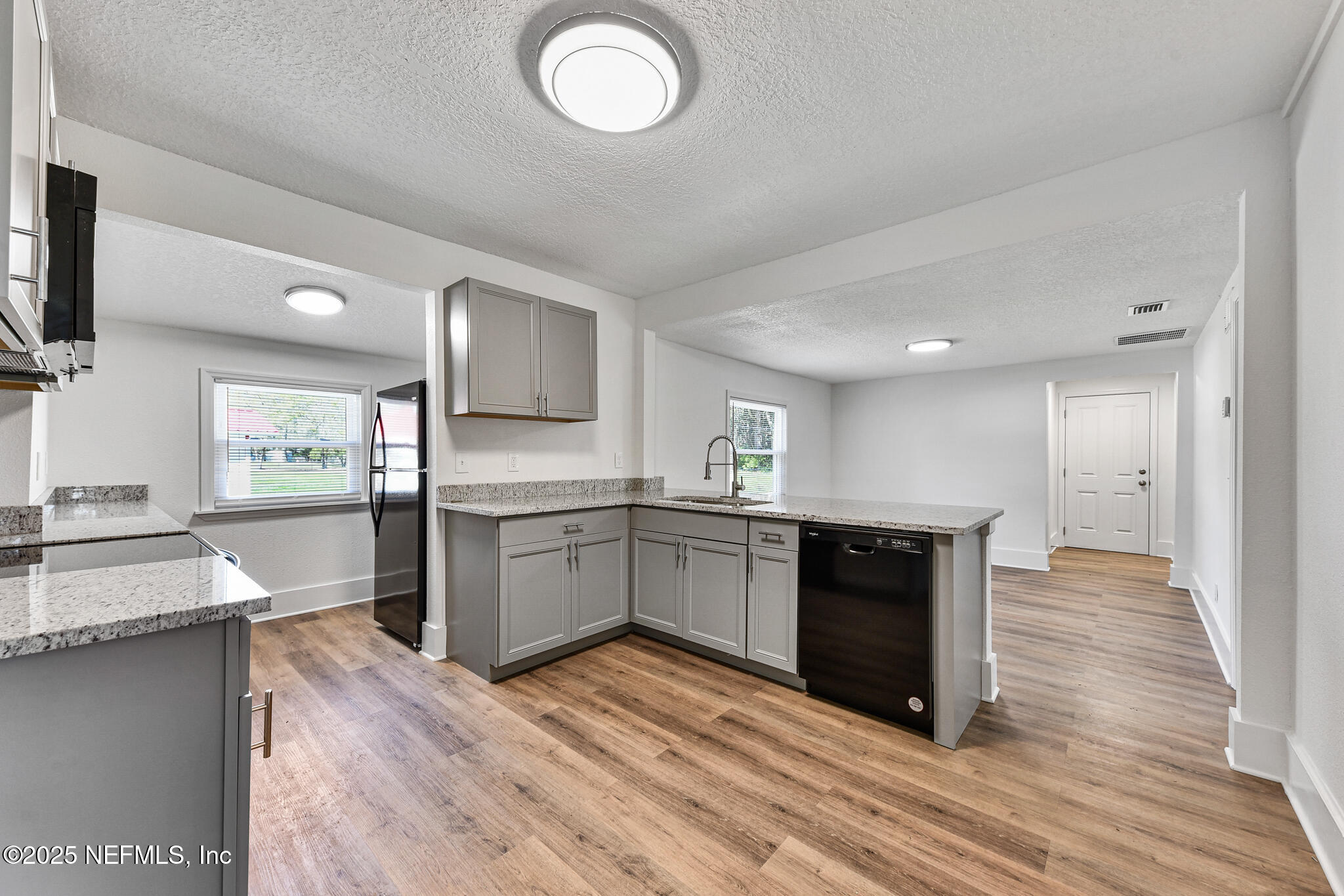 123 Mccallman Road Jacksonville, FL 32218 - Photo 39 of 62 a large kitchen with cabinets wooden floor and stainless steel appliances