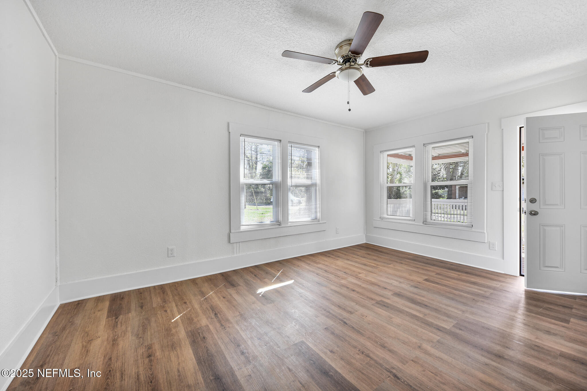 123 Mccallman Road Jacksonville, FL 32218 - Photo 40 of 62 a view of empty room with wooden floor and fan