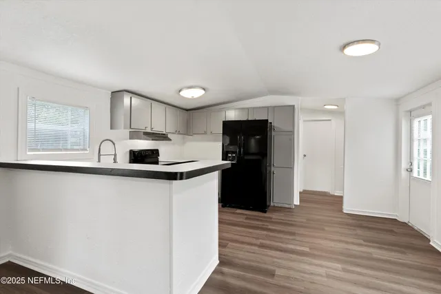 a kitchen with stainless steel appliances a refrigerator sink and stove