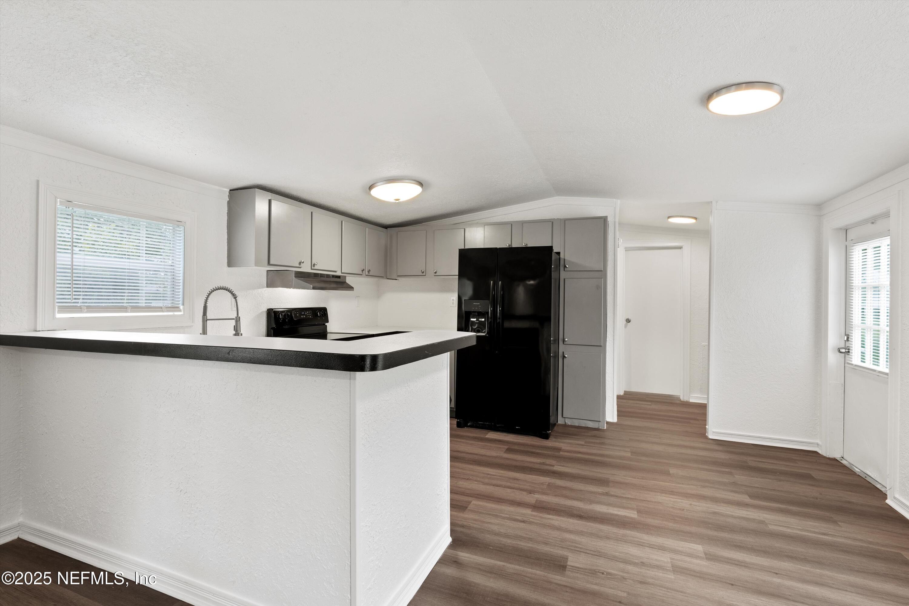123 Mccallman Road Jacksonville, FL 32218 - Photo 4 of 62 a kitchen with stainless steel appliances a refrigerator sink and stove