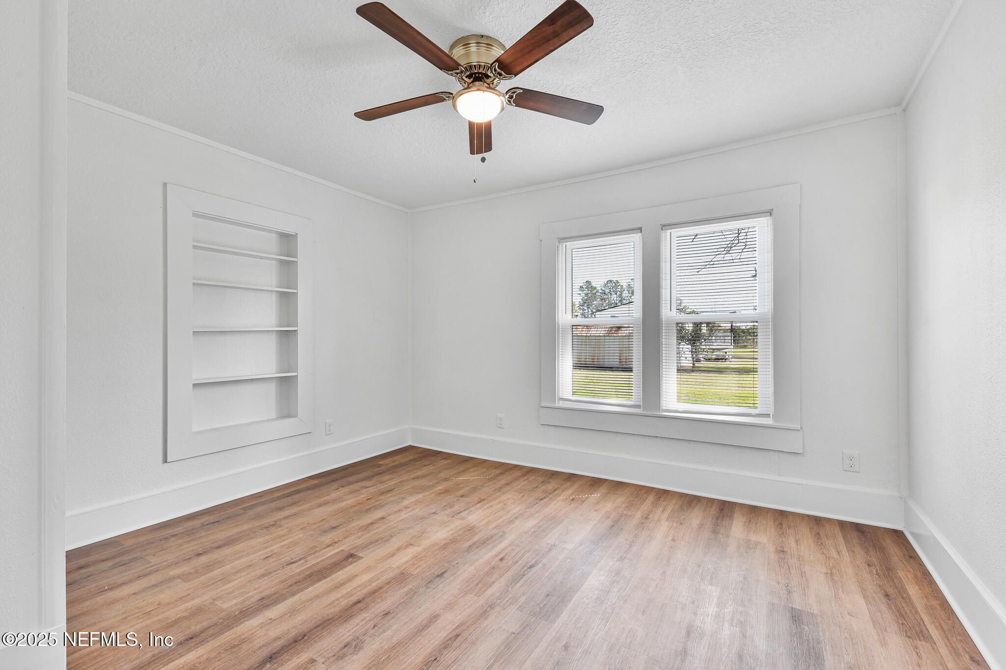 123 Mccallman Road Jacksonville, FL 32218 - Photo 41 of 62 an empty room with wooden floor closet and windows