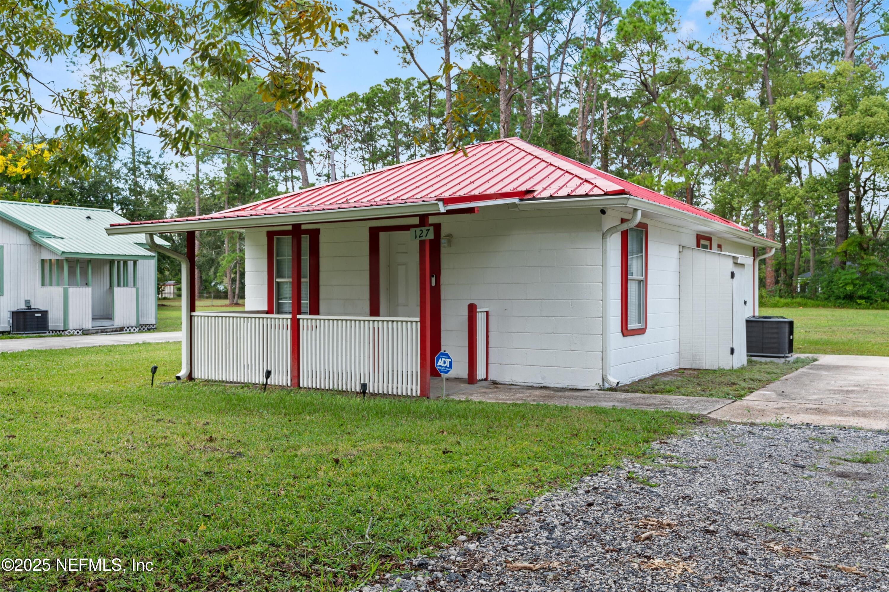 123 Mccallman Road Jacksonville, FL 32218 - Photo 49 of 62 a front view of a house with a yard and garage