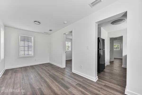 an aerial view of residential houses with outdoor space and trees