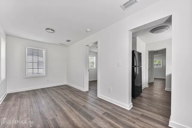 an aerial view of residential houses with outdoor space and trees