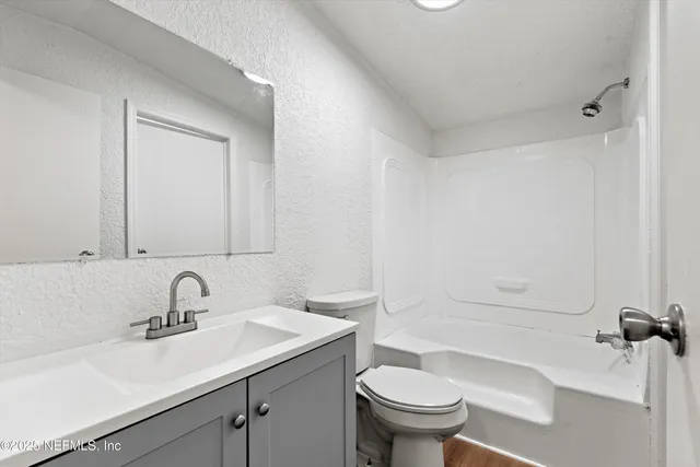 a bathroom with a sink toilet and a tub