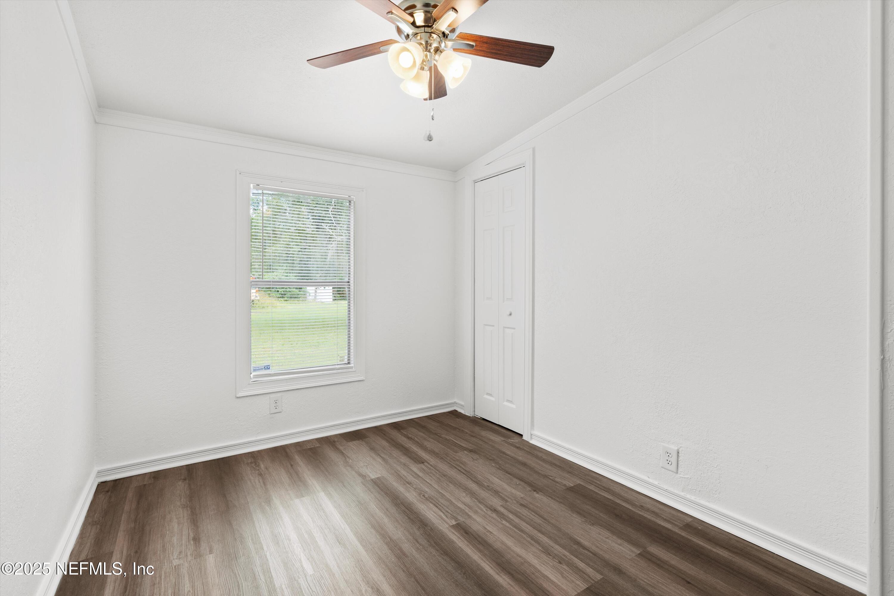 123 Mccallman Road Jacksonville, FL 32218 - Photo 10 of 62 an empty room with a window and a fan