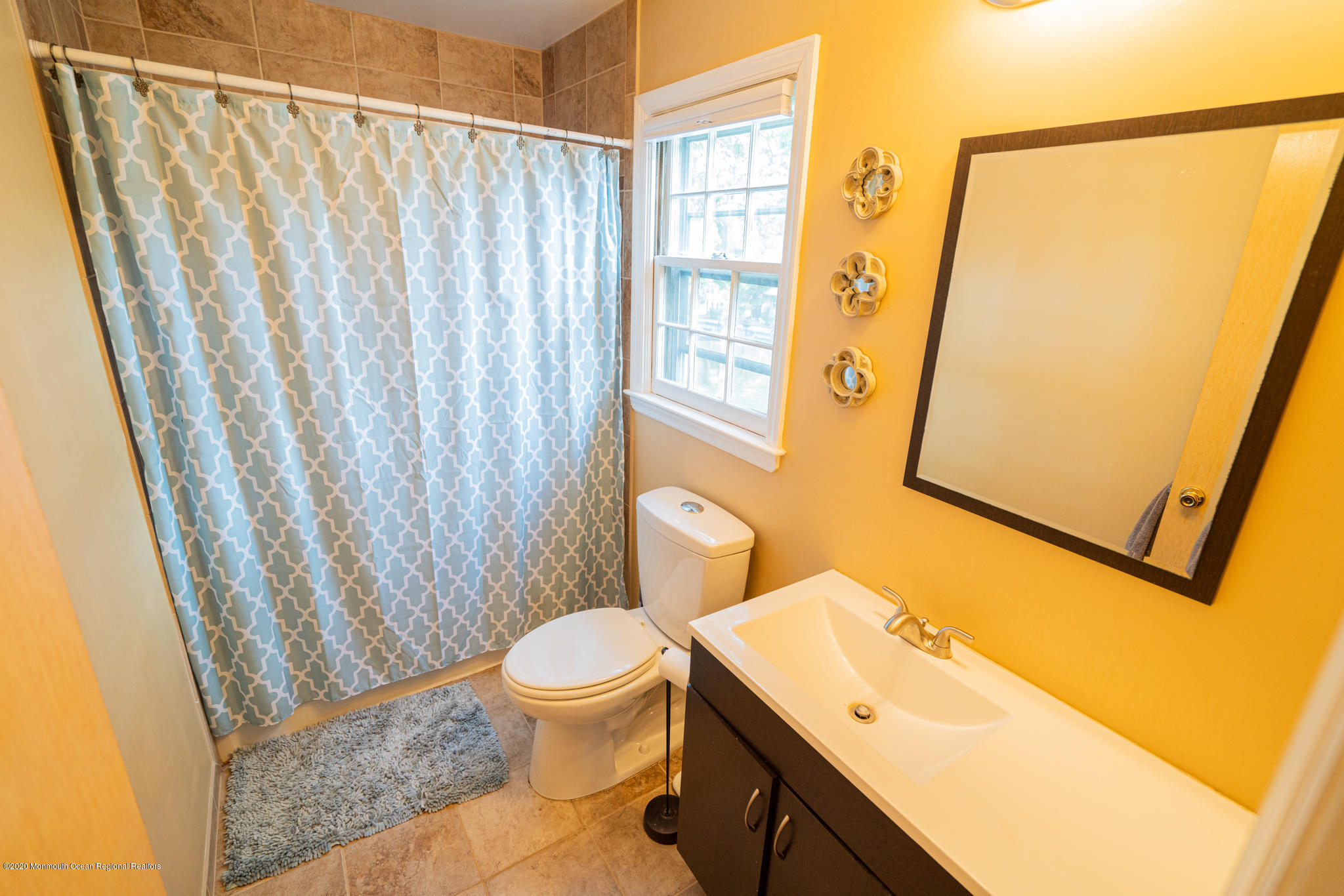 28 Holiday Road Manalapan, NJ 07726 - Photo 16 of 27 a bathroom with a sink a toilet a mirror and a shower